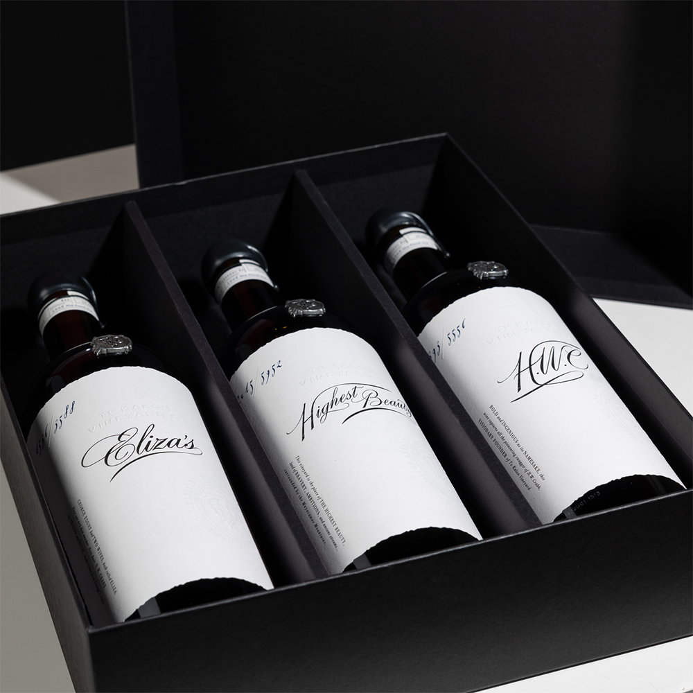 3 bottles of wine - Eliza's Red Wine, Highest Beauty Cabernet Sauvignon, and HWC Cabernet Sauvignon - in a black gift box