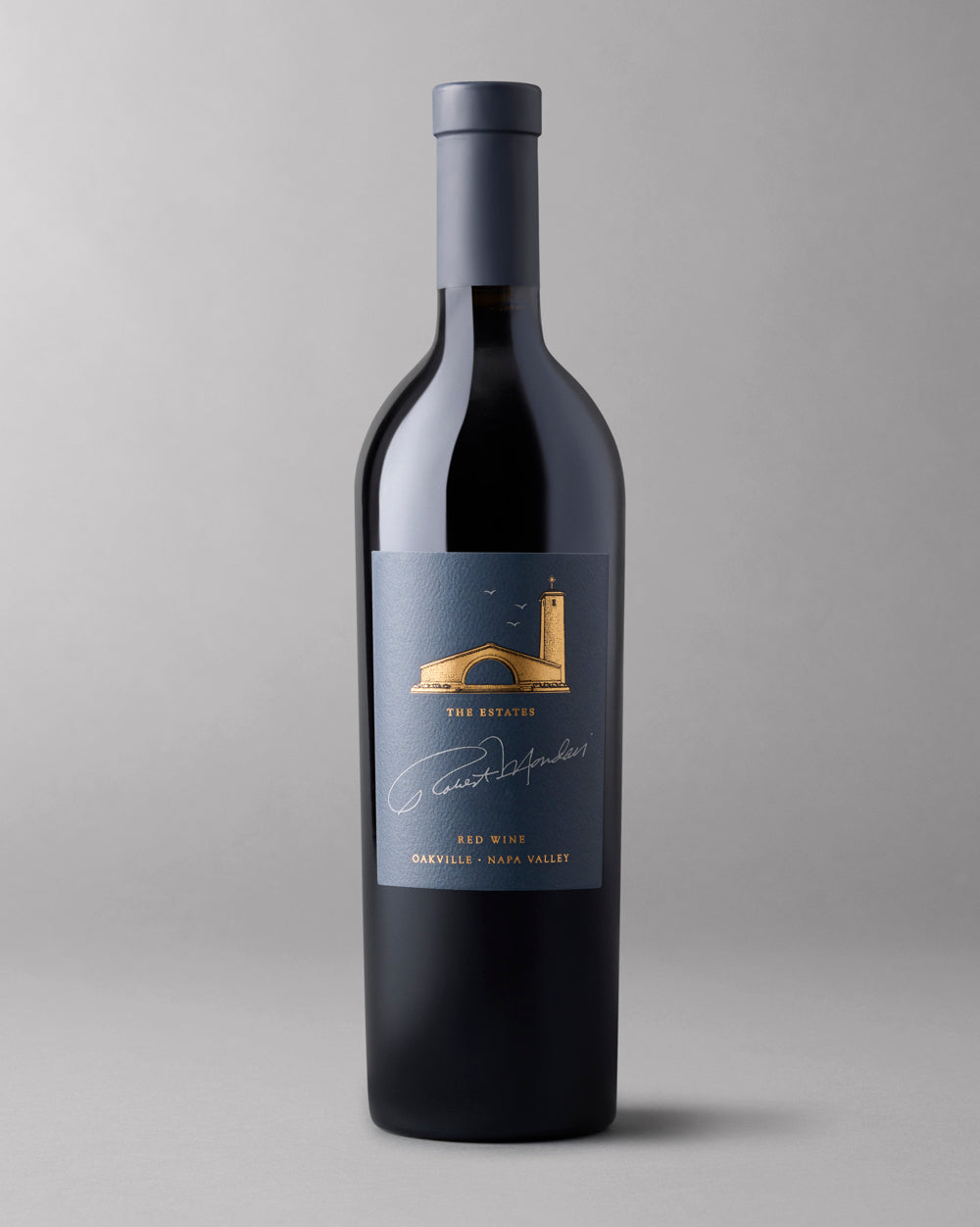 A bottle of 2021 The Estates Red Wine Oakville on a grey background.