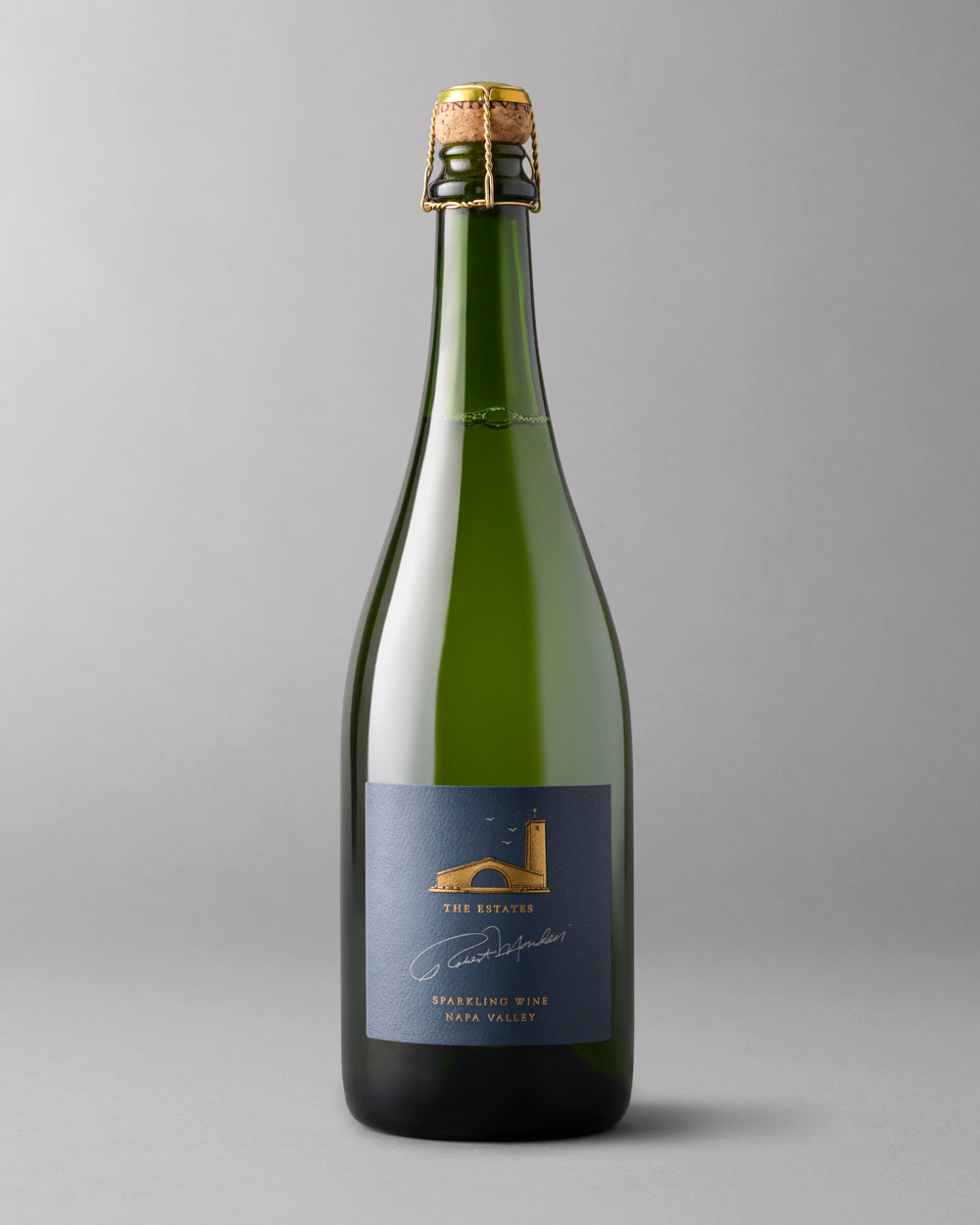 Single bottle of sparkling wine on a grey background