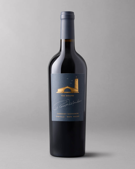 A bottle of 2021 The Estates Cabernet Sauvignon Oakville on a grey background.
