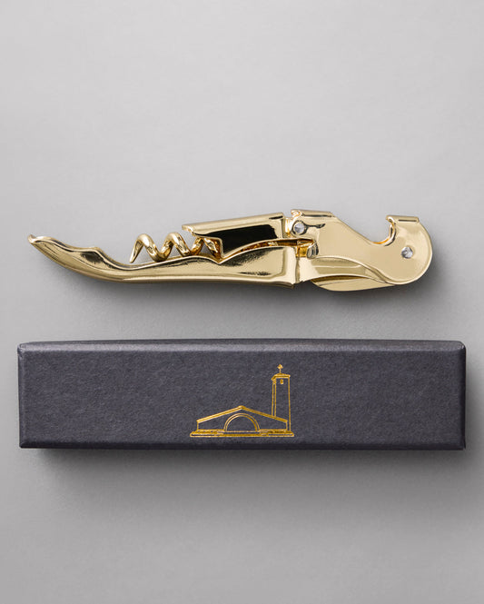 A gold waiter-style corkscrew embossed with Robert Mondavi Winery on the handle